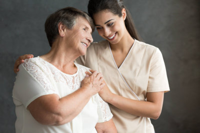 caregiver hugging the elderly