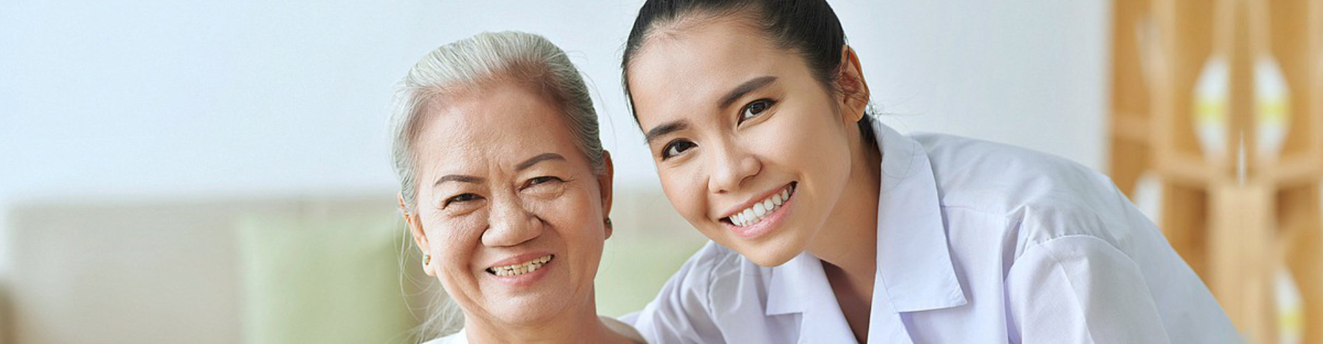 caregiver hugging the elderly